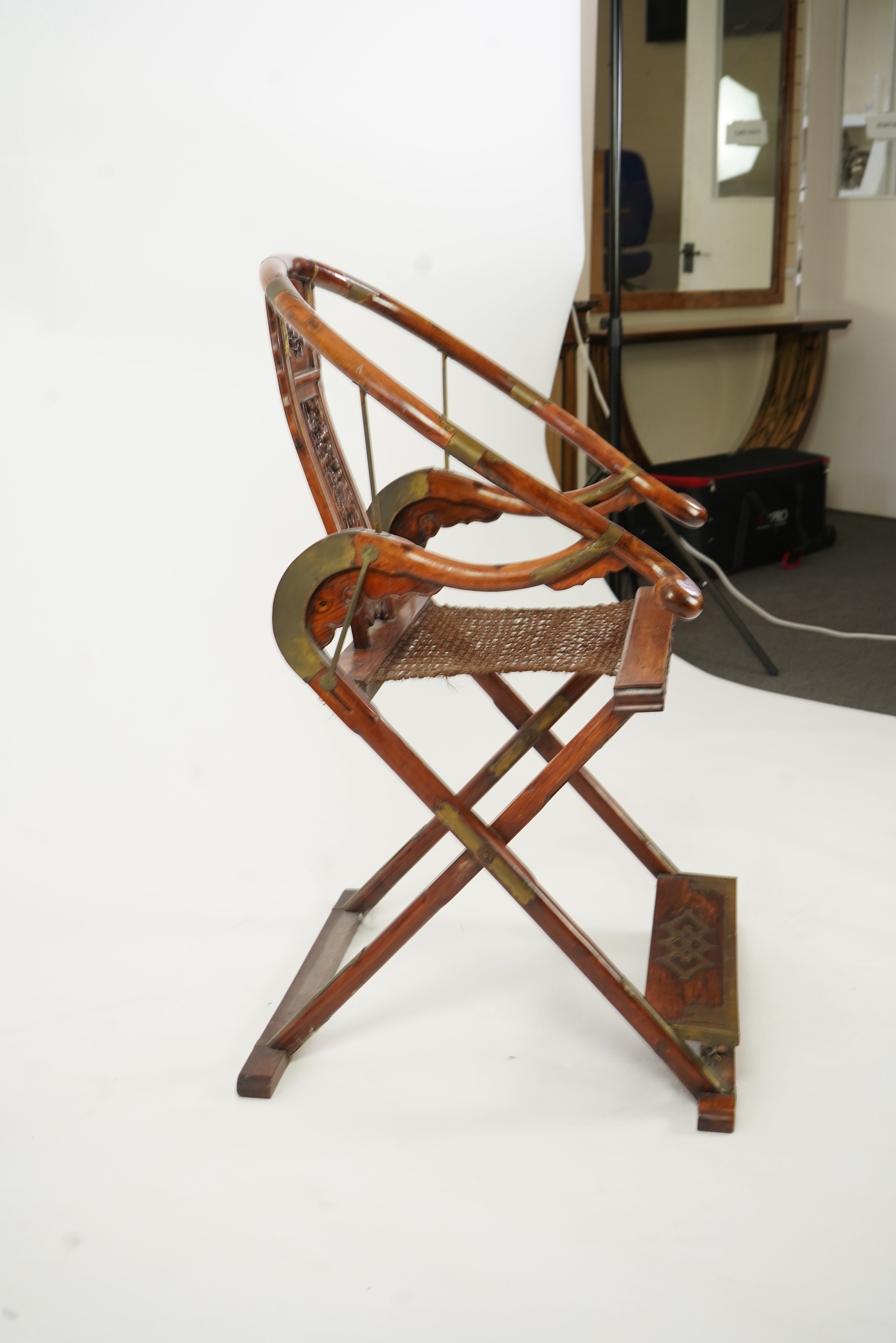 A Chinese huanghuali, hongmu and brass mounted folding hunting chair, jiaoyi, early 20th century